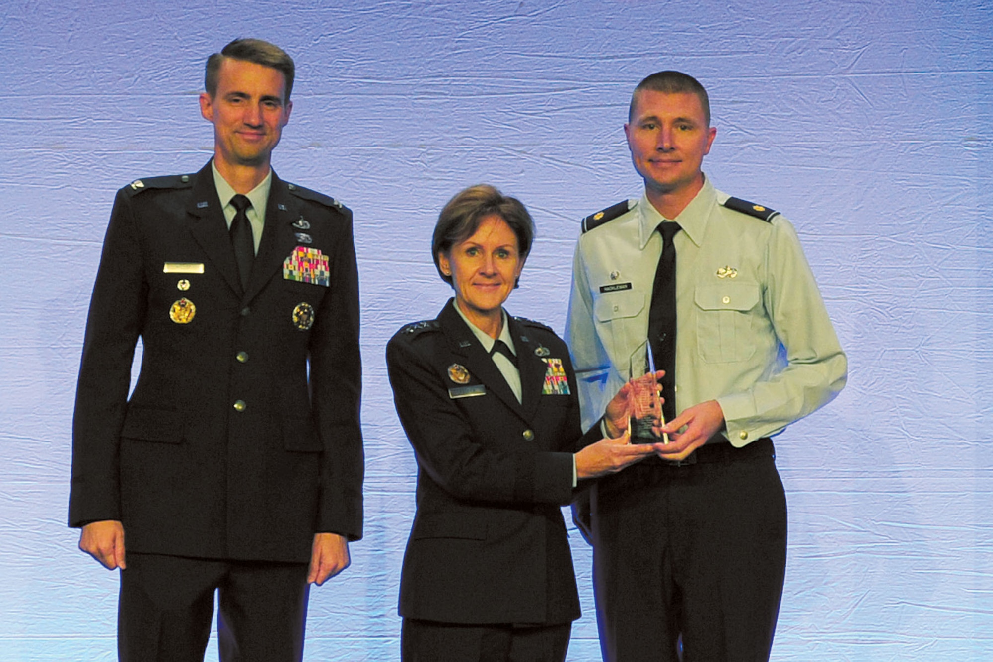 KIRTLAND AFB, N.M. -- Maj. Andrew Hackleman, 898th Munitions Squadron commander, right, was recently awarded the Maj. Gen. Saunders Chapter Distinguished Service Award for outstanding leadership as president of the Lt. Gen. Marquez Chapter of the Logistics Officers Association at Kirtland AFB. (Courtesy photo)