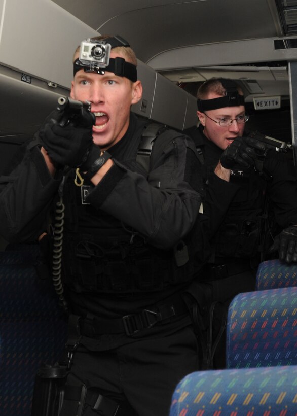 Senior Airman Daniel Ruiz, 11th Security Forces Squadron elite guardsman and Andrews Emergency Services Team member, and Staff Sgt. Greg Twigg, 11th SFS response force leader and Andrews EST member, lead a tubular assault during an anti-hijacking exercise conducted Nov. 9, 2012, at the Joint Training Facility at Baltimore Washington International Airport, Md. The Andrews EST and Raven team conducted the training in a decommissioned Boeing 757 and used simunitions, or “dummy rounds” to create a more realistic atmosphere. (U.S. Air Force photo/ Senior Airman Bahja J. Jones) 