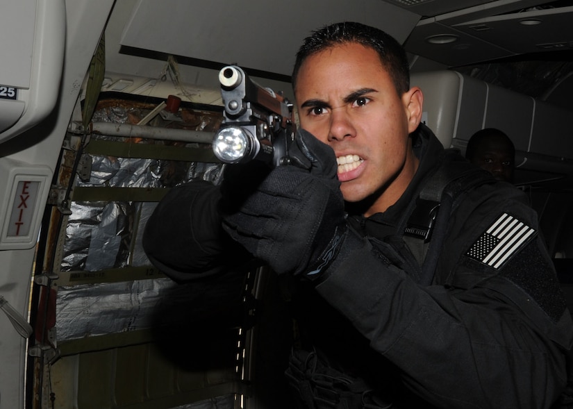 Senior Airman Gabriell Vieira, 11th Security Forces Squadron elite guardsman and Andrews Emergency Services Team member, takes control of his sector of responsibility during an anti-hijacking exercise conducted Nov. 9, 2012, at the Joint Training Facility at Baltimore Washington International Airport, Md. The exercise was a joint effort between the Andrews Emergency Services Team and the Raven team where they practiced tubular assaults during a mock hijacking scenario. (U.S. Air Force photo/ Senior Airman Bahja J. Jones) 