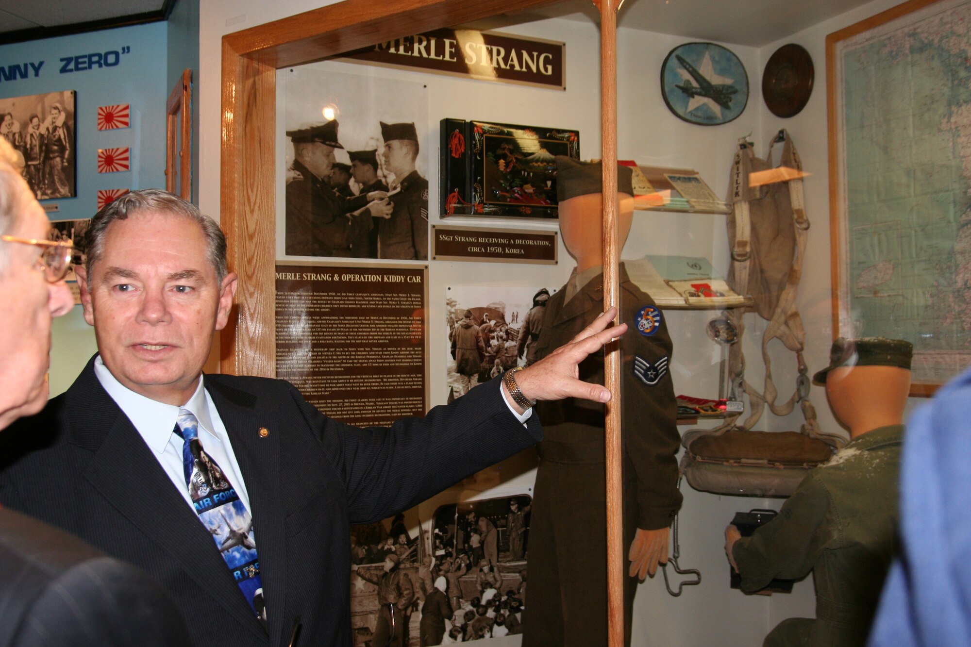 Bill Chivalette, curator for the Enlisted Heritage Hall, discusses the Staff Sgt. Merle Y. Strang exhibit during a dedication ceremony Nov. 5.  The exhibit features Strang’s uniform and information about his efforts in 1950 to rescue 6,000 orphaned and homeless children in Seoul, where he served as a chaplain assistant.  (Air Force photo by Kelly Deichert)