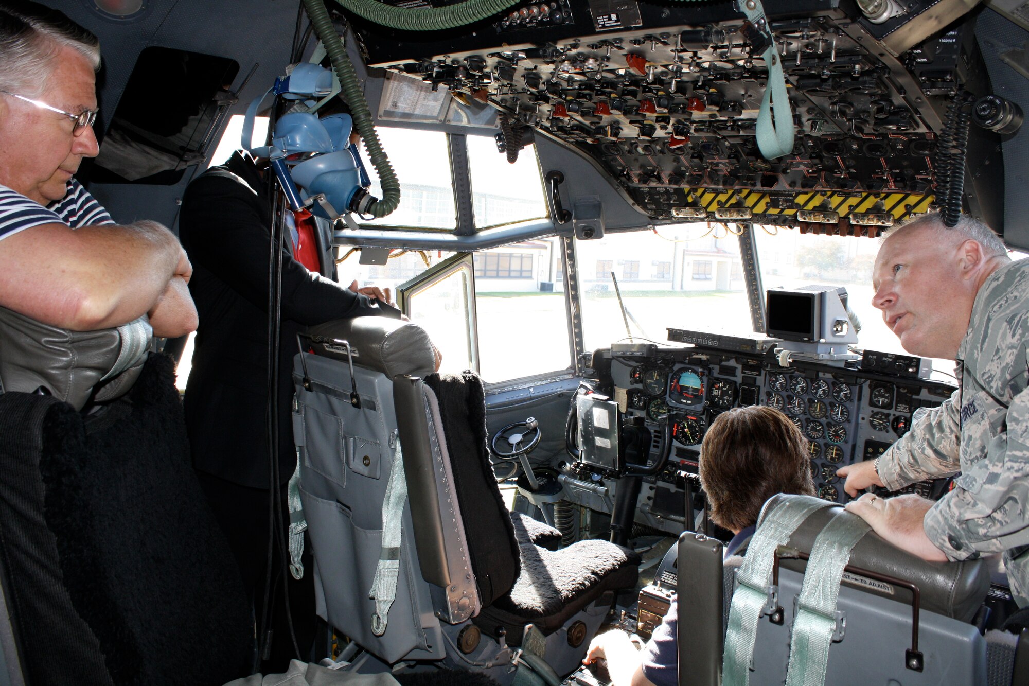 Bottom left, retired Lt. Col. Jerry Casper enjoys his return visit to a C-130 as Lt. Col. Jerry Lobb, 908th Airlift Wing public affairs officer, gave the tour, sharing history and engineer information. Nancy Dasinger sits in the copilot's chair on her first visit aboard the C-130 cargo aircraft. (Air Force photo by Rebecca Burylo)