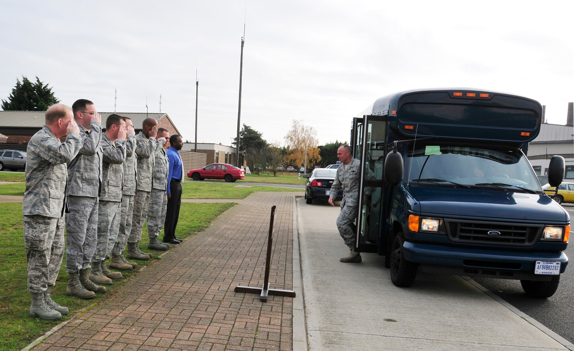 ROYAL AIR FORCE LAKENHEATH, England - Col. Scott Benza (left), 48th Mission Support Group commander, and other Airmen of the 48th Fighter Wing salute as Lt. Gen. Craig Franklin, 3rd Air Force commander, as he exits the bus at the installation deployment readiness center, Nov. 14, 2012. Franklin visited RAF Lakenheath as part of his immersion since becoming the 3rd AF commander in March. He visited the hospital, IDRC, Hangars 6 and 7, fire department, 56th Rescue Squadron and other areas around the base to familiarize himself with the 48th Fighter Wing members and mission. (U.S. Air Force photo by Senior Airman Tiffany M. Grigg) 