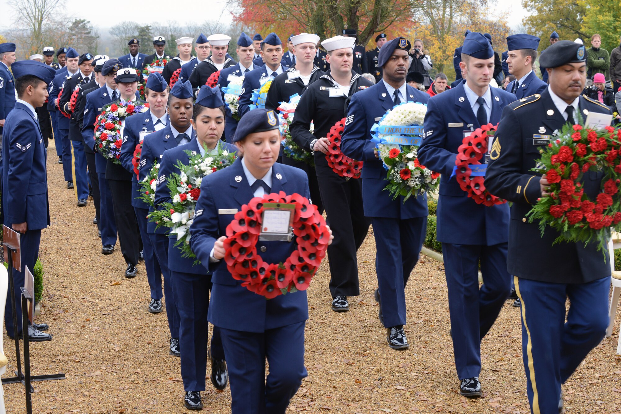 CAMBRIDGE, United Kingdom – Servicemembers from the U.S. Air Force, U.S. Navy and U.S. Army bear wreaths to the base of Tablets of the Missing during the Veteran’s Day ceremony at Cambridge American Cemetery Nov. 12. The wreaths were laid on benches sitting at the base of the Tablets of the Missing, which contains the names of 5,126 missing during World War II. Cambridge American Cemetery is the only World War II American cemetery in England. (U.S. Air Force photo by Staff Sgt. Brian Stives)