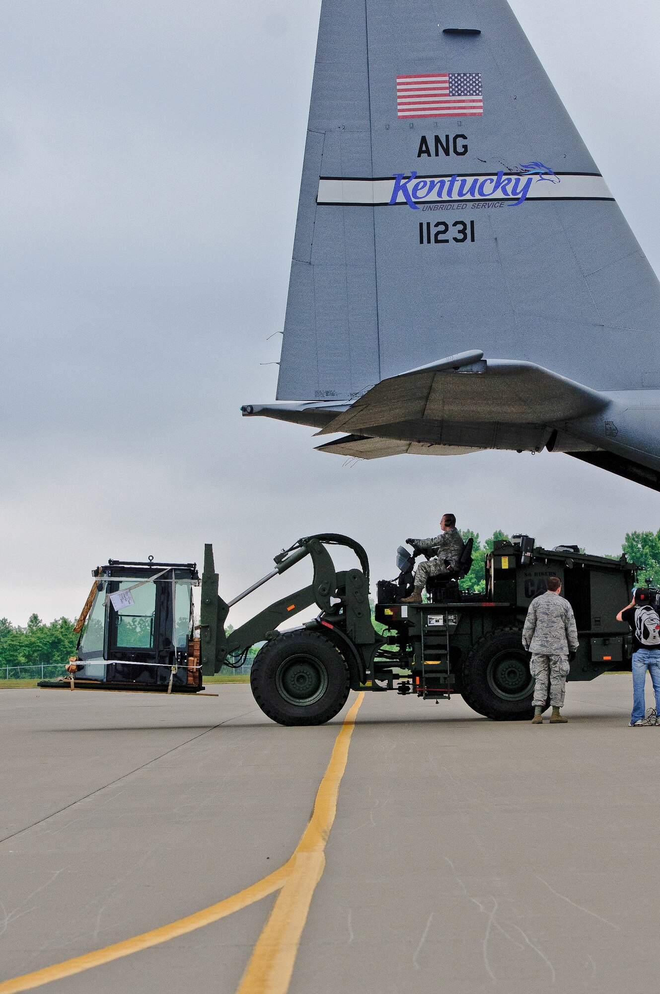 Members of the Kentucky Air National Guard unload a forklift from a C-130 aircraft during an earthquake-response exercise May 14, 2012, at Fort Campbell, Ky. About 20 Airmen from the 123rd Contingency Response Group and 123rd Special Tactics Squadron deployed to demonstrate their preparedness for an initial response after a natural disaster. The Kentucky Air Guard's Initial Response Hub team is the first of its kind in the nation. No other unit in the U.S. military has the same breadth of capabilities housed in one unit, with the C-130 aircraft to permit immediate response. (U.S. Air Force photo by Senior Airman Maxwell Rechel)