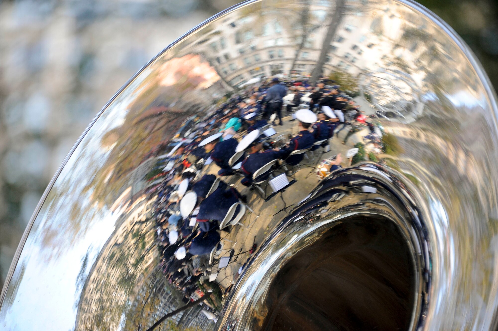 From the reflection of a tuba, the U.S. Coast Guard band prepares for the opening ceremony of the New York City Veterans Day parade Nov. 11, 2012. This year's Veterans Day parade honored the U.S. Coast Guard as the featured service. (U.S. Air Force photo by Airman 1st Class Ryan Throneberry/Released)