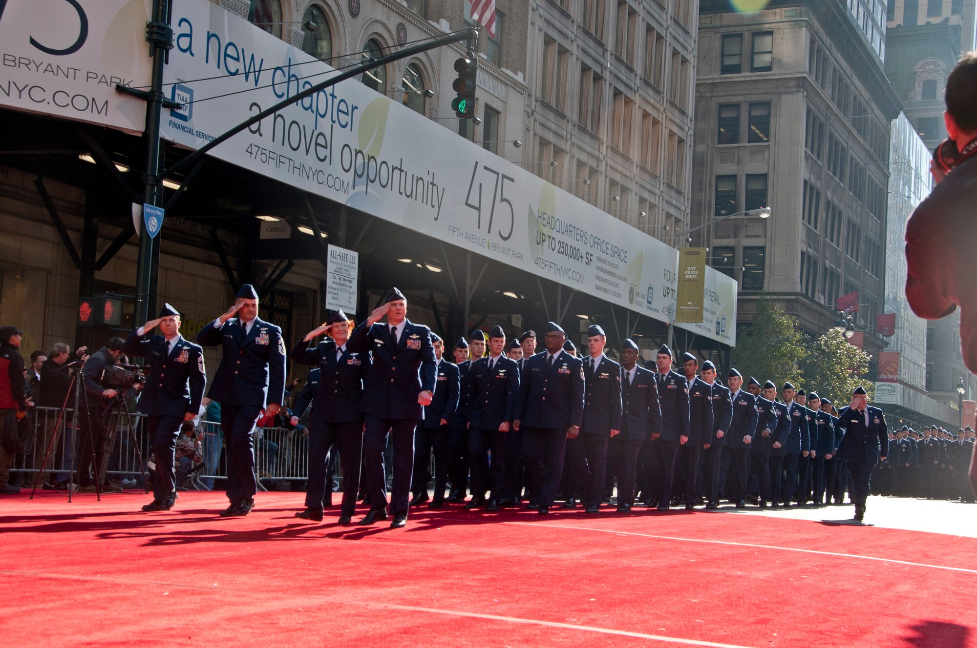 Airmen from Joint Base McGuire-Dix-Lakehurst, N.J., render salutes to senior military leaders in the review stand in front of the New York Public Library during the New York City Veterans Day Parade Nov. 11, 2012. More than 130 Airmen, made up of members from the 305th and 514th Air Mobility wings, 621st Contingency Response Wing, 87th Air Base Wing and the U.S. Air Force Expeditionary Center, marched in this year's parade. (U.S. Air Force photo by Staff Sgt. David Carbajal/Released)