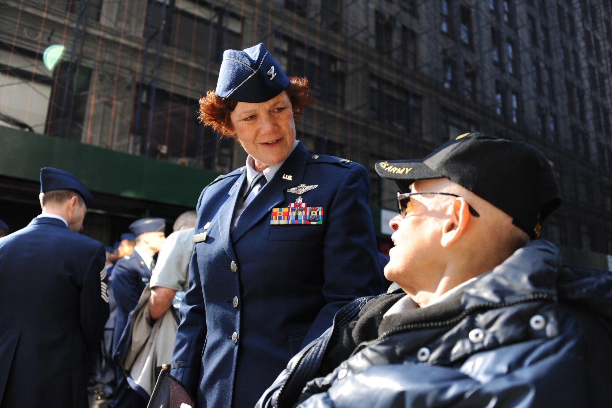 Col. Paulette Schank, 514th Aerospace Medicine Squadron commander, speaks to a U.S. Army veteran about his military experiences before the New York City Veterans Day Parade Nov. 11, 2012. Thousands of spectators and military veterans surrounded 5th Ave. to observe this year's 93rd iteration of the parade. (U.S Air Force photo by Airman Sean Crowe/Released)