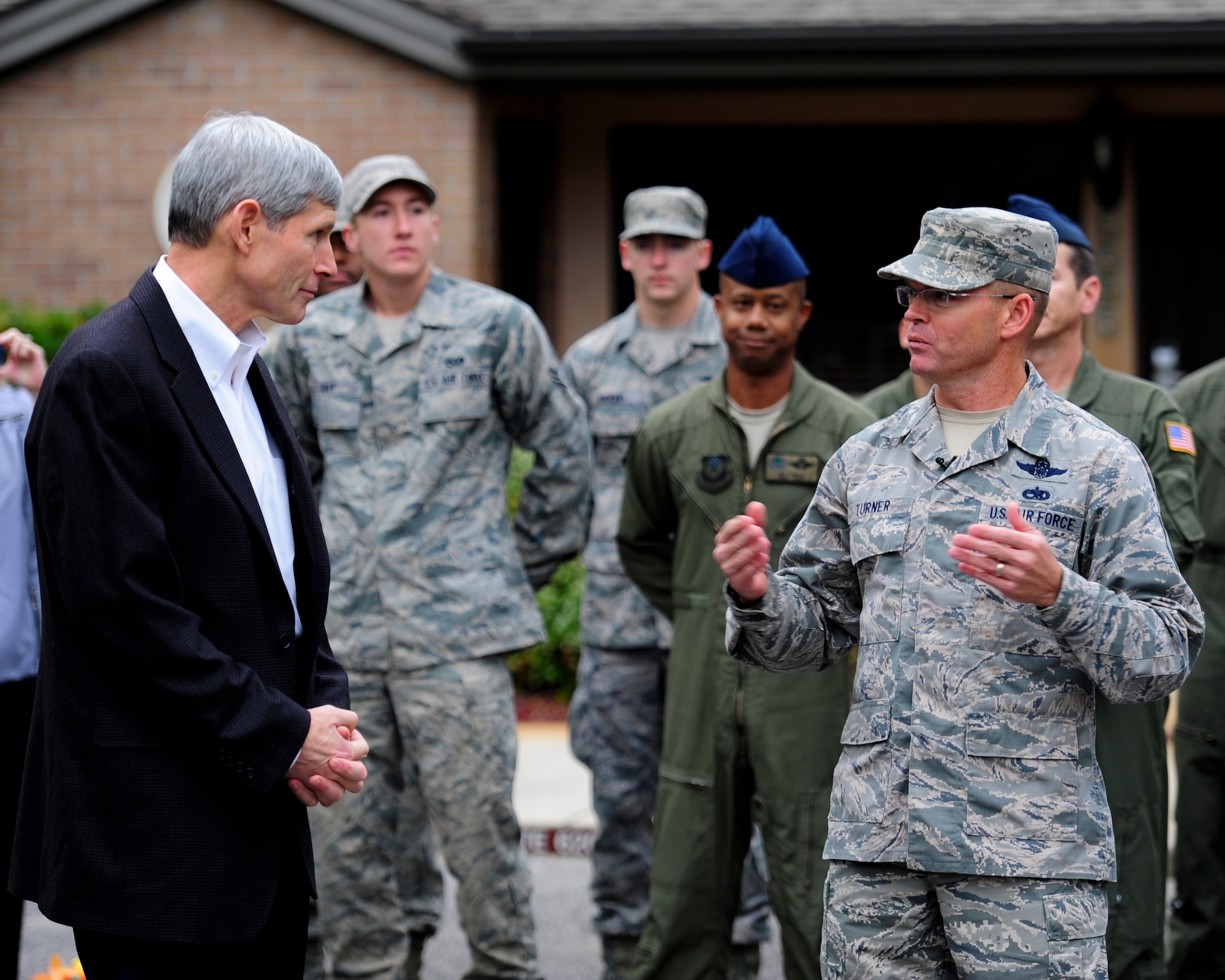 Retired U.S. Air Force Gen. Norton Schwartz, former Chief of Staff of the Air Force, left, listens as Chief Master Sgt. Bill Turner, command chief of Air Force Special Operations Command, welcomes him back to Hurlburt Field while outside the distinguished visitors quarters at Hurlburt Field, Fla., Nov. 15, 2012. Turner then informed Schwartz of his nomination to be inducted into The Order of the Sword, the highest honor the enlisted corps can bestow upon an individual in recognition of significant contributions to the enlisted force. (U.S. Air Force photo / Airman 1st Class Christopher Williams) (RELEASED)