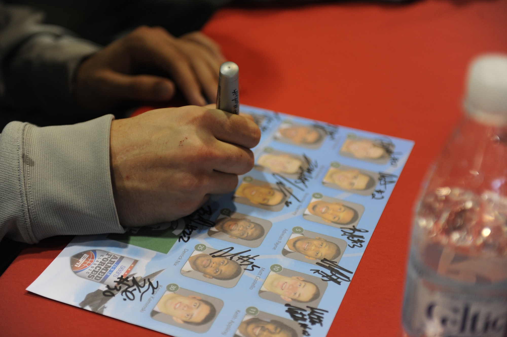 Colby Wollenman, Michigan State forward, signs a team picture for members of Team Ramstein during Resiliency Day in Hangar 1 on Ramstein Air Base, Germany, Nov. 9, 2012. Resiliency Day is an opportunity for Airmen of all ranks to take a break from normal duties and acknowledge achievements from the past few months. (U.S. Air Force photo/Airman 1st Class Holly Cook)