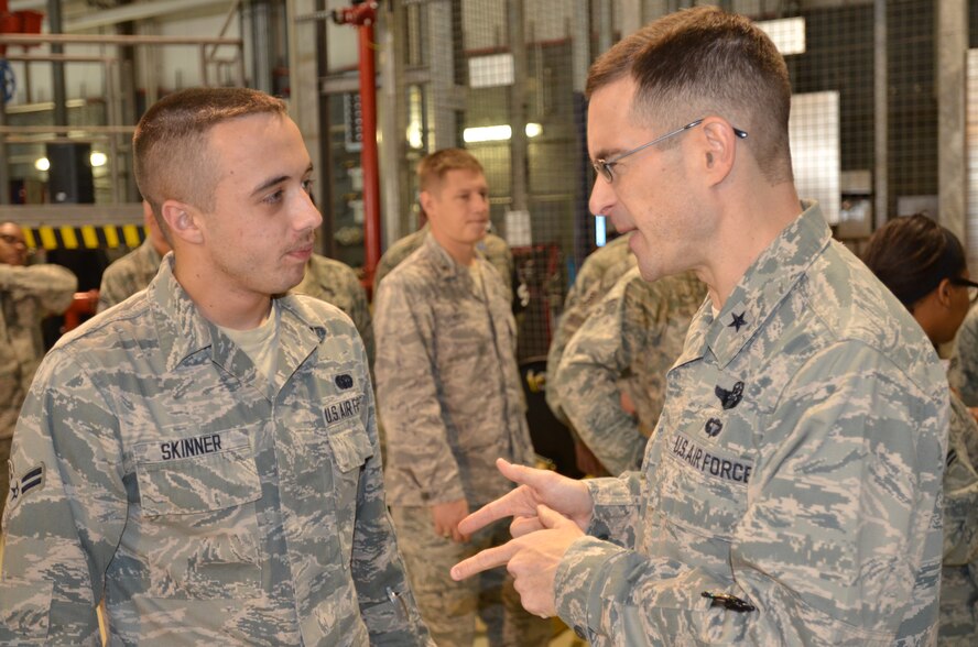 Brig. Gen. C.K. Hyde, 86th Airlift Wing commander, speaks with Airman 1st Class Dane Skinner, 86th Communications Squadron tactical line admin, during Resiliency Day in Hangar 1 on Ramstein Air Base, Germany, Nov. 9, 2012. Resiliency Day is an opportunity for Airmen of all ranks to take a break from normal duties and acknowledge achievements from the past few months. (U.S. Air Force photo/Airman 1st Class Jordan Castelan)