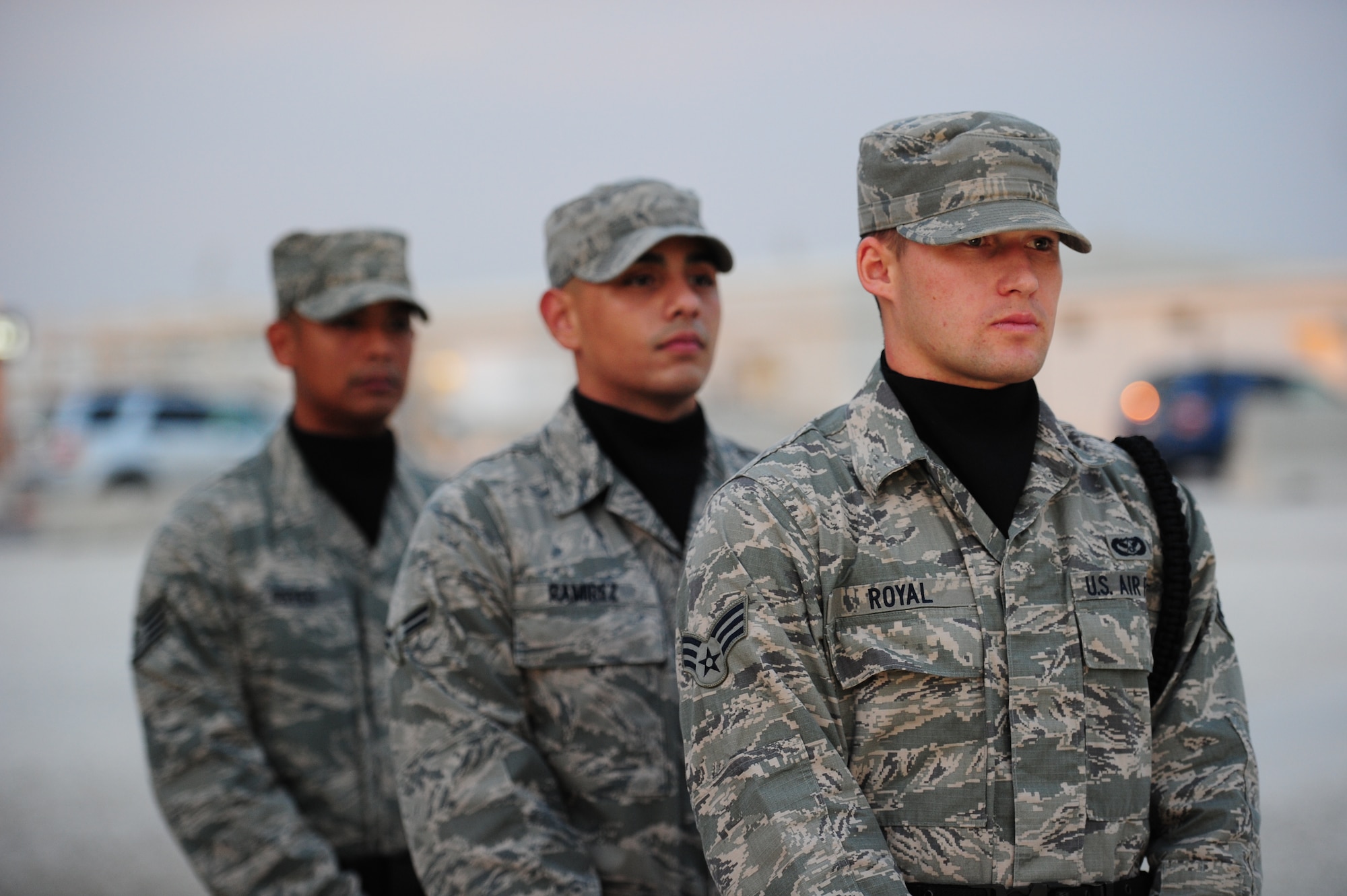 SOUTHWEST ASIA -  From left to right, Staff Sgt Fernando Reyes, Airman 1st Class Christian Ramirez and Senior Airman Joseph Royal, members of the 379th Air Expeditionary Wing Honor Guard members, stand by during a Veteran’s Day Ceremony Nov. 11, 2012. (U.S. Air Force photo/Master Sgt. Brendan Kavanaugh)