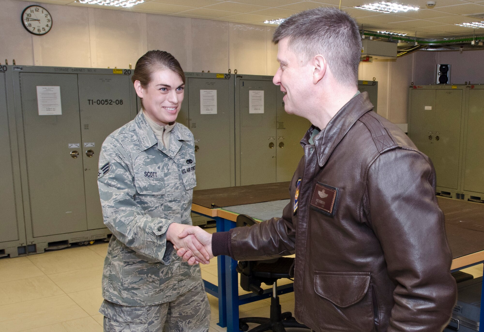 ROYAL AIR FORCE LAKENHEATH, England - Senior Airman Rachel Scott, 48th Component Maintenance Squadron avionics systems journeyman and native of Aberdeen, S.D., shakes hands with Col. Kyle Robinson, 48th Fighter Wing commander, after speaking about electronic warfare equipment Nov. 15, 2012. Robinson visited the avionics intermediate shop to meet the Airmen and gain insight into avionics equipment.  (U.S. Air Force photo by Staff Sgt. Stephen Linch)