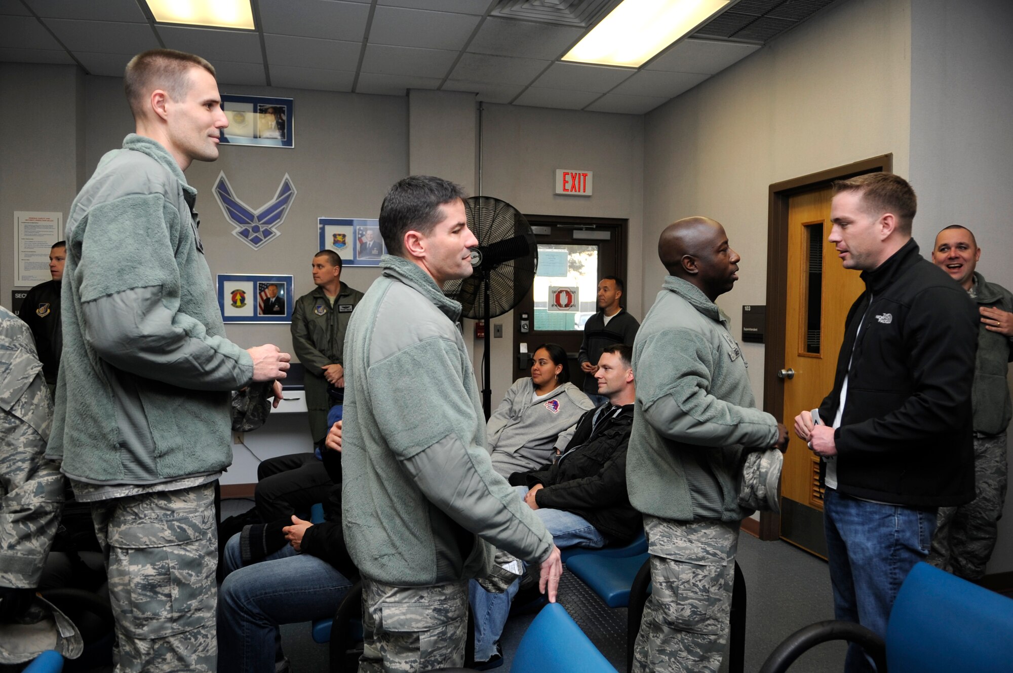 Master Sgt. Jessie Green, 8th Operations Support Squadron, congratulates Staff Sgt. Adam Crown, 8th OSS, for being promoted to technical sergeant under the Stripes for Exceptional Performers program, Nov. 15, 2012, at Kunsan Air Base, Republic of Korea. Each year, about 300 Airmen are selected under the selective program to be immediately promoted for their exceptional performance. He received notification while waiting for his military airlift to his next duty station. (U.S. Air Force photo/Senior Airman Brigitte N. Brantley)