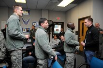 Master Sgt. Jessie Green, 8th Operations Support Squadron, congratulates Staff Sgt. Adam Crown, 8th OSS, for being promoted to technical sergeant under the Stripes for Exceptional Performers program, Nov. 15, 2012, at Kunsan Air Base, Republic of Korea. Each year, about 300 Airmen are selected under the selective program to be immediately promoted for their exceptional performance. He received notification while waiting for his military airlift to his next duty station. (U.S. Air Force photo/Senior Airman Brigitte N. Brantley)