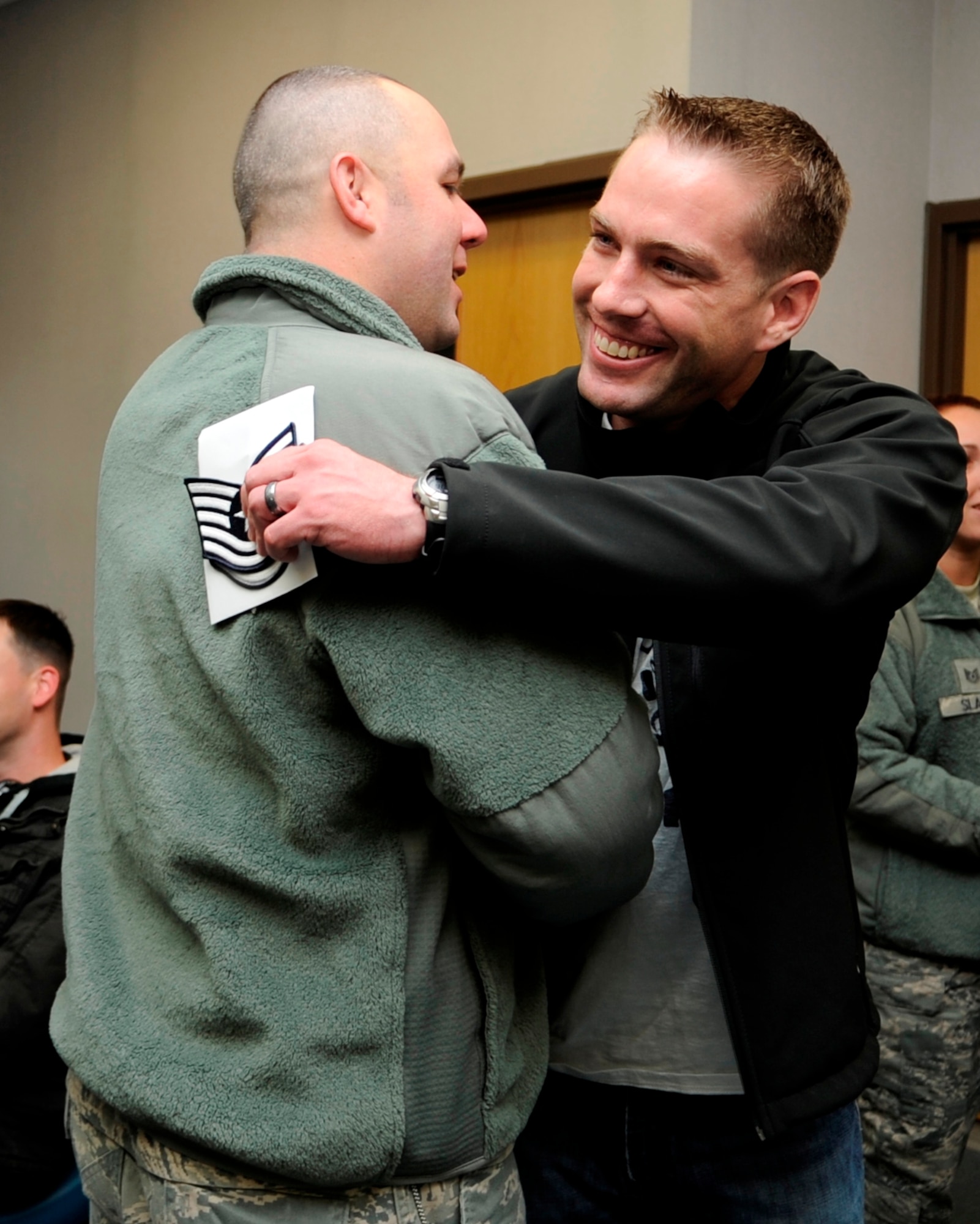 Staff Sgt. Adam Crown, right, 8th Operations Support Squadron, receives congratulations from Chief Master Sgt. Daniel Stein, 8th Operations Group superintendent, after receiving a surprise promotion under the Stripes for Exceptional Performers program Nov. 15, 2012, at Kunsan Air Base, Republic of Korea. Under the STEP program, Airmen are immediately promoted to the next rank for clearly exceptional circumstances. He received notification while waiting for his military airlift to his next duty station. (U.S. Air Force photo/Senior Airman Brigitte N. Brantley)