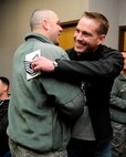 Staff Sgt. Adam Crown, right, 8th Operations Support Squadron, receives congratulations from Chief Master Sgt. Daniel Stein, 8th Operations Group superintendent, after receiving a surprise promotion under the Stripes for Exceptional Performers program Nov. 15, 2012, at Kunsan Air Base, Republic of Korea. Under the STEP program, Airmen are immediately promoted to the next rank for clearly exceptional circumstances. He received notification while waiting for his military airlift to his next duty station. (U.S. Air Force photo/Senior Airman Brigitte N. Brantley)
