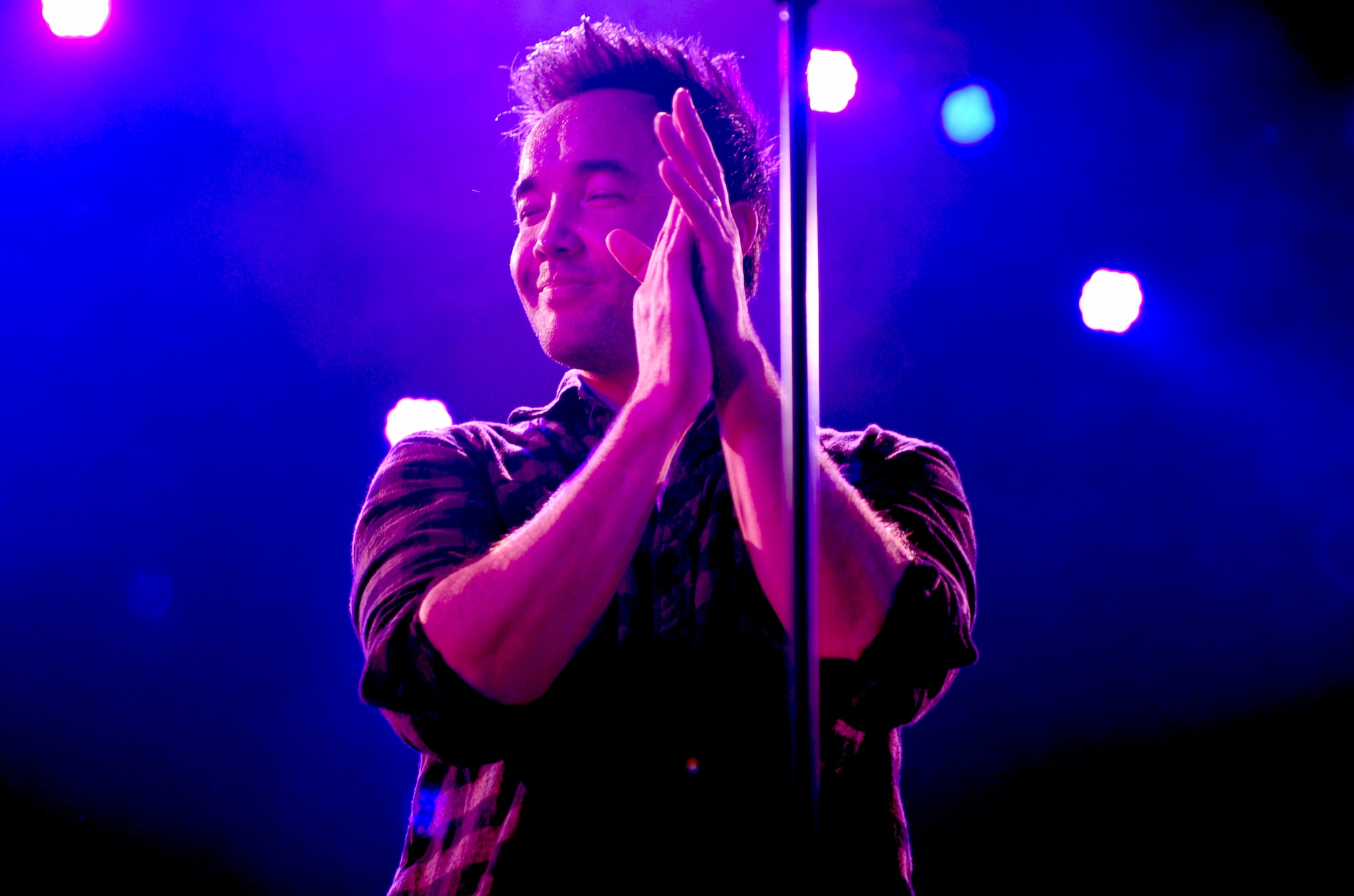 Doug Robb, the lead singer for Hoobastank, an American rock band, performs for service members and their families from across Okinawa on Kadena Air Base, Japan, Nov. 15, 2012. Thousands of service members and their families came out to the Emery Bowling Center for the free concert put on by the 18th Force Support Squadron. (U.S. Air Force photo/Staff Sgt. Sara Csurilla)