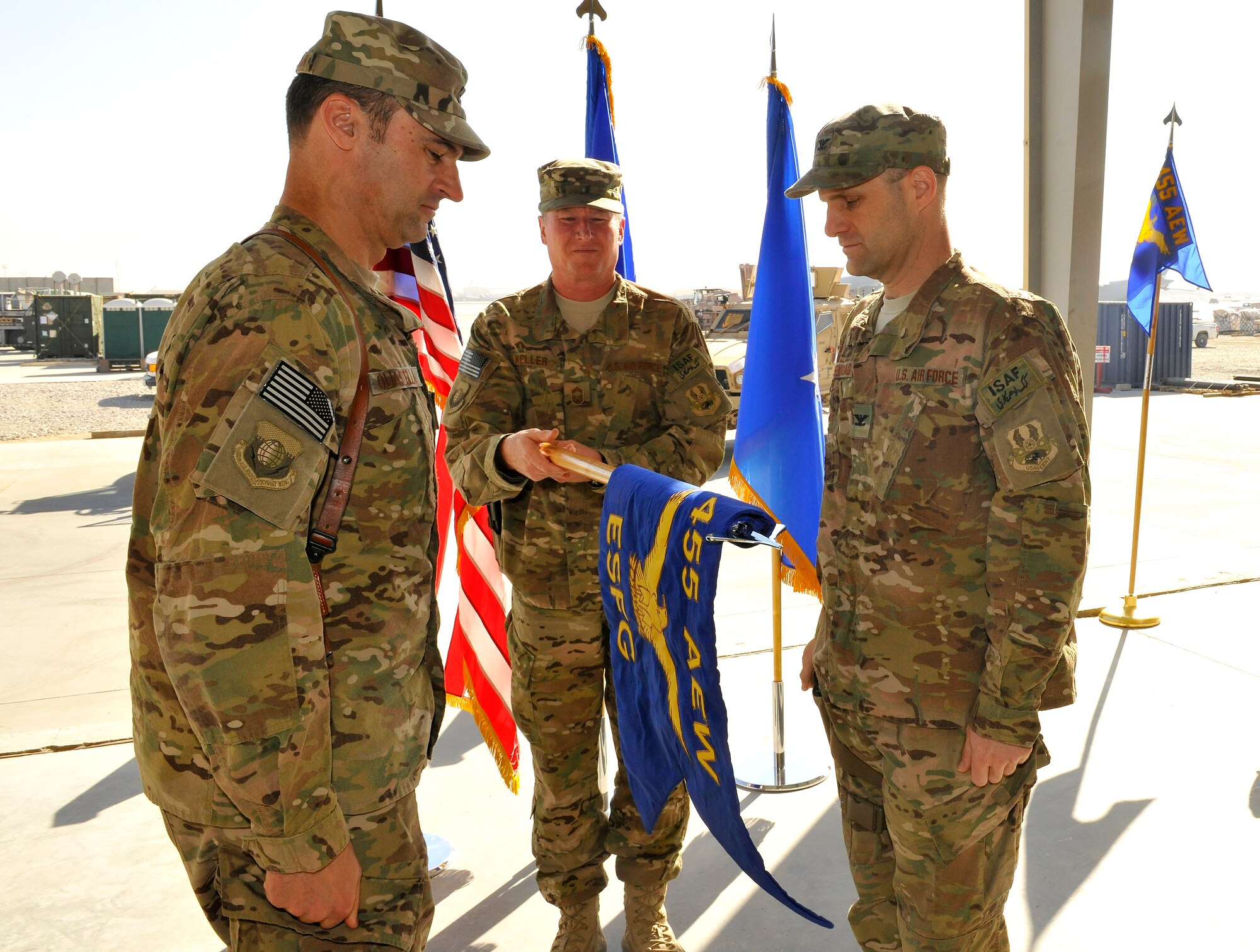 Brig. Gen. Joseph Guastella (middle), 455th Air Expeditionary Wing commander, Chief Master Sgt. Ed Keller (middle), 455th Expeditionary Mission Support Group chief enlisted manager, and Col. Brian Greenroad, 455th Expeditionary Security Forces Group commander, unveil the newly formed 455th ESFG guidon at Bagram Airfield, Afghanistan, Nov. 14, 2012.  Due to the increased responsibility of taking over the 300 square mile “security zone” from the Army, the 455th Expeditionary Security Forces Group now has 1,300 joint and coalition personnel from several functional areas.  (U.S. Air Force photo/Senior Airman Chris Willis)