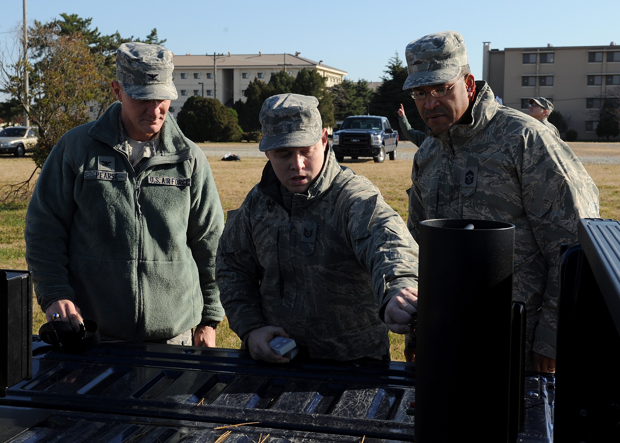 Col. John Pearse, 8th Fighter Wing commander, and Chief Master Sgt. Phillip Robinson, 8th FW command chief, listen to Tech. Sgt. Jason Singer, 8th FW  wing plans NCOIC, explain how the new ground-blast simulators function during a demonstration on Kunsan Air Base, Republic of Korea, Nov. 15, 2012. The GBS are used during exercises to simulate mortar and rocket attacks. (U.S. Air Force photo/Staff Sgt. Jonathan Fowler)