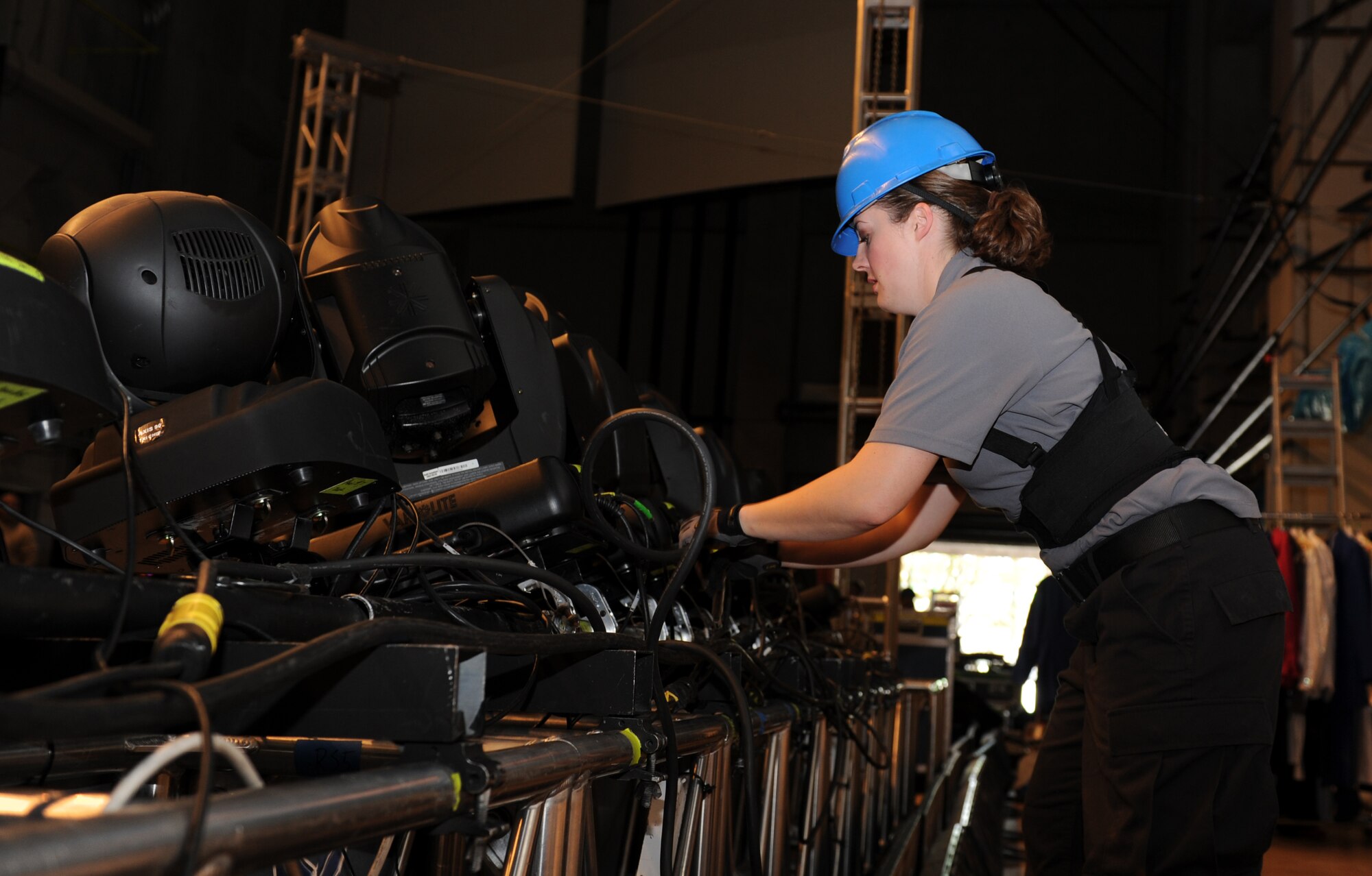 U.S. Air Force Staff Sgt. Katie McGuire, Tops in Blue keyboardist, sets up lights in preparation for the 2012 Tops in Blue “Listen” tour at the Misawa Civic Center, Misawa City, Japan, Nov. 14, 2012. Before performing for audience members, the Tops in Blue team set up all their own stage equipment and lights for the show. (U.S. Air Force photo by Airman 1st Class Kia Atkins)