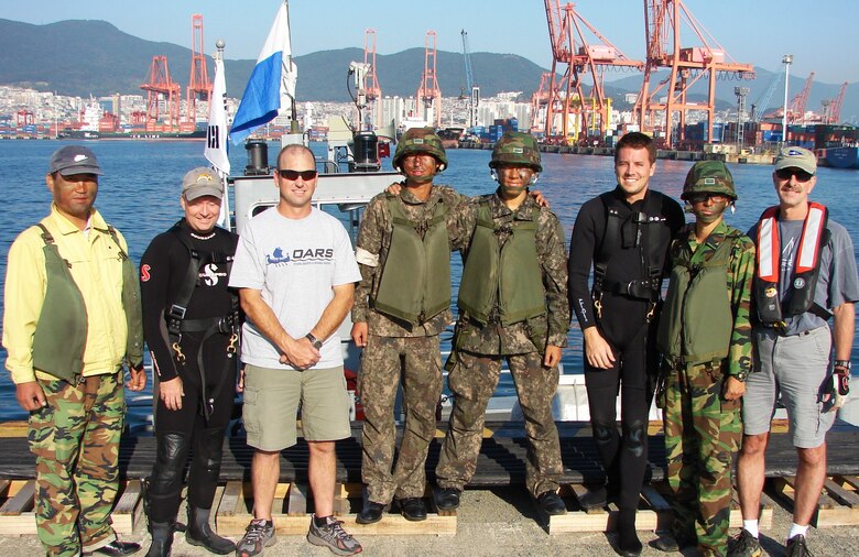 Flanked by members of the Republic of Korea (ROK) Army who served as boat crew for the USACE Forward Response Dive Team during their October underwater inspection of Pier 8 in Busan are (from left to right) Shanon Chader of Buffalo District, Team Lead Todd Manny of Portland, Kyle Tanner of Nashville and Ed Gawarecki of Buffalo.