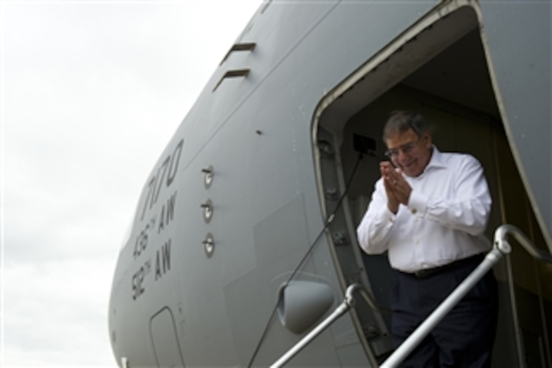 Secretary of Defense Leon E. Panetta gives the traditional Cambodian thank you from the steps of his aircraft before departing Siem Reap, Cambodia, on Nov. 16, 2012.  Panetta was in Cambodia to talk to his counterparts during the Association of Southeast Asian Nations defense ministers meeting.  The association with member states of Burma, Brunei Darussalam, Cambodia, Indonesia, Laos, Malaysia, the Philippines, Singapore, Thailand and Vietnam was formed in 1967.  