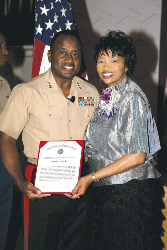 Lt. Gen. Willie Williams, director, Marine Corps Staff, Washington, D.C., stands with Jonelle Cooks after her recent retirement at the Base Chapel.
