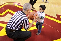 Cristian McGinnis, 3, hands the head referee the ball for the opening tip-off at the University of Minnesota men's basketball game at Williams Arena on Nov. 12. For additional imagery from the event, visit www.facebook.com/rstwincities. 