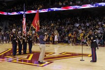 Recruiters from the Bloomington, Minn., office perform their color guard duties while Marine musician Gunnery Sgt. Jason Knuckles kicks off the University of Minnesota men's basketball game with a rousing rendition of the National Anthem at Williams Arena on Nov. 12. For additional imagery from the event, visit www.facebook.com/rstwincities.