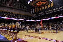 The University of Minnesota men's basketball cheerleaders put their routines on hold to listen to Marine musician Gunnery Sgt. Jason Knuckles play a rousing rendition of the National Anthem at Williams Arena on Nov. 12. For additional imagery fro the event, visit www.facebook.com/rstwincities.