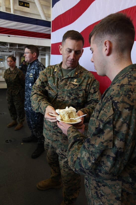 Naval Base San Diego, Calif. - Marines with the 11th Marine Expeditionary Unit eat a traditional birthday cake after attending a live recording of ESPN's College Gameday alongside sailors aboard USS San Diego Nov. 10. Maj. Louis Lecher, the 11th MEU operations officer, was the oldest Marine present and he shared a piece of cake with Lance Cpl. Christian Milburn, 11th MEU data clerk, who was the youngest Marine present. (U.S. Marine Corps photo by Cpl. Chad J. Pulliam)

