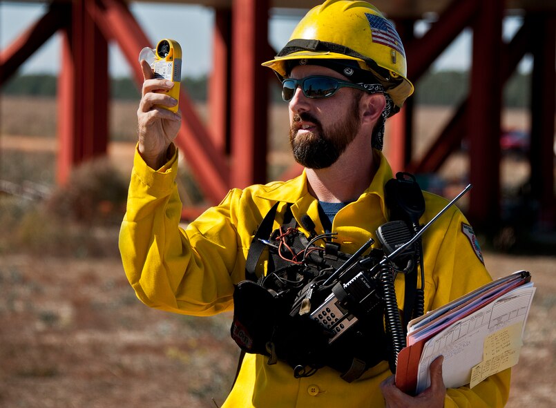 Brett Williams, a fire ecologist for natural resources management takes wind readings prior to a prescribed fire conducted at Eglin Air Force Base Nov. 11-12. More than 90 scientists from the Combustion-Atmospheric-Dynamics-Research-Experiments team, sent from institutions all over the world, set up instruments to record meteorology, smoke particulates and other fire phenomena. (U.S. Air Force photo/Randy Gon)