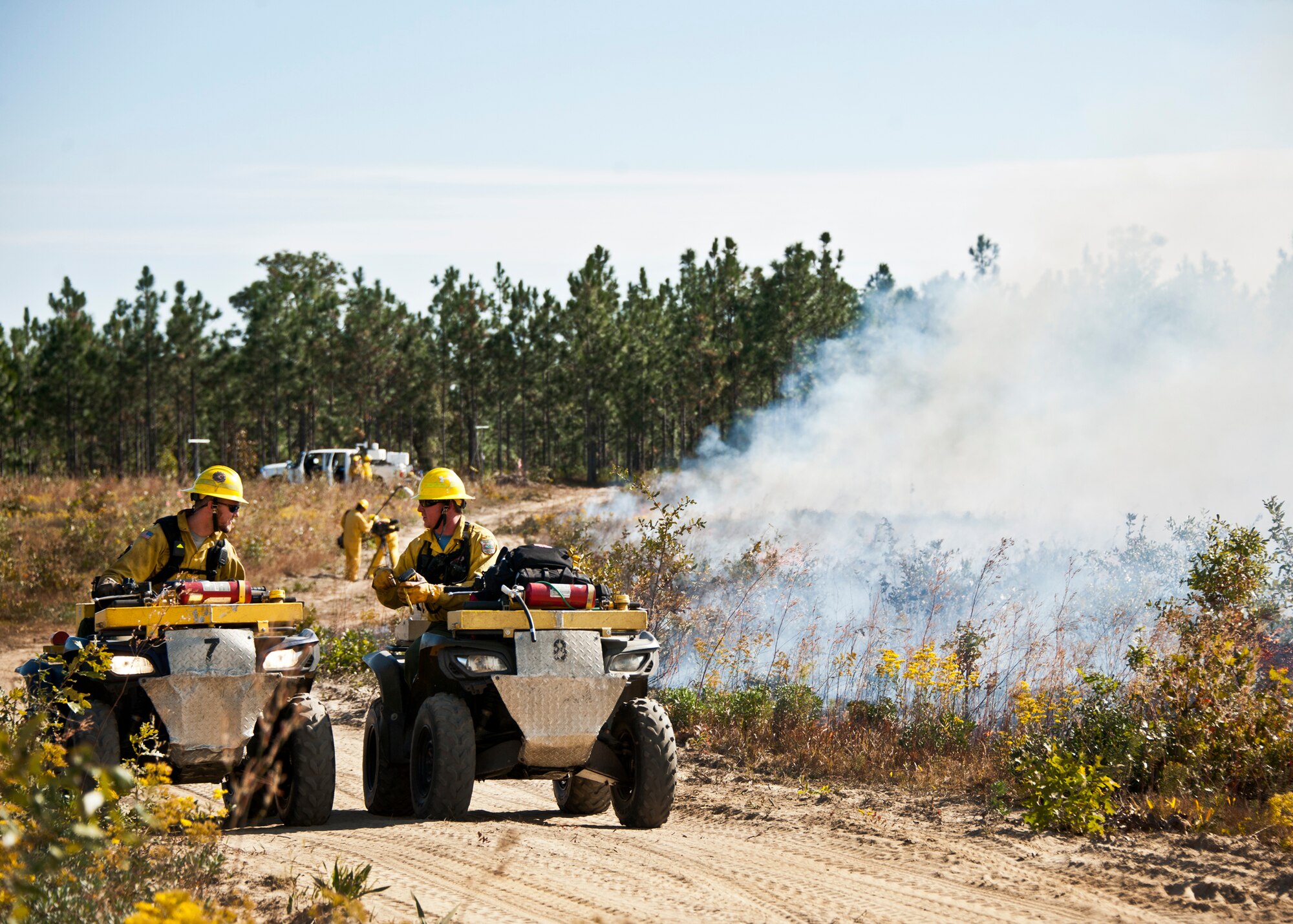 Two members of Jackson Guard describe the conditions during a prescribed fire conducted at Eglin Air Force Base Nov. 11-12.  More than 90 scientists from the Combustion-Atmospheric-Dynamics-Research-Experiments team, sent from institutions all over the world, set up instruments to record meteorology, smoke particulates and other fire phenomena. (U.S. Air Force photo/Randy Gon)