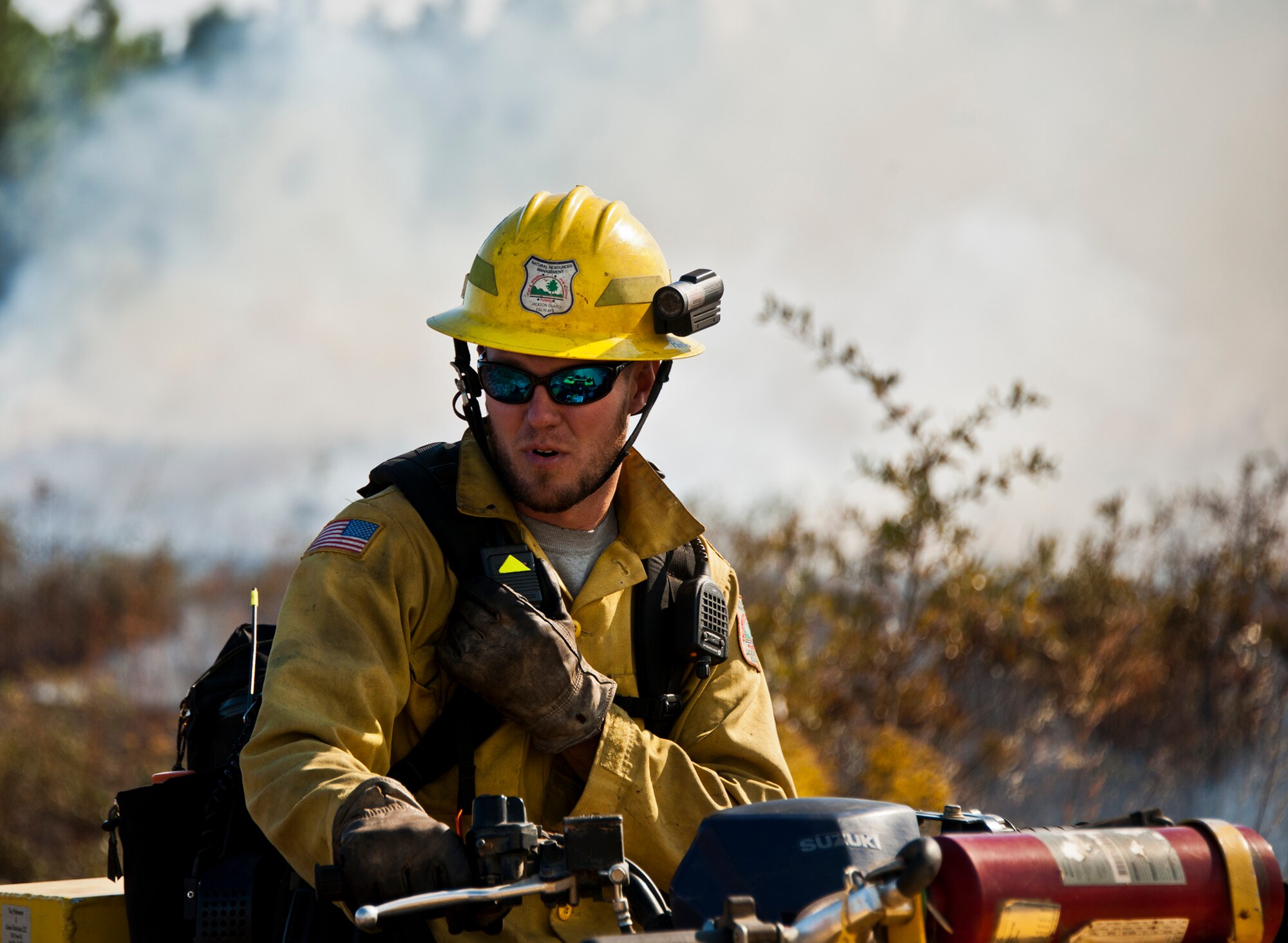 A member of the Jackson Guard describes the situation during a prescribed fire conducted at Eglin Air Force Base Nov. 11-12. More than 90 scientists from the Combustion-Atmospheric-Dynamics-Research-Experiments team, sent from institutions all over the world, set up instruments to record meteorology, smoke particulates and other fire phenomena. (U.S. Air Force photo/Randy Gon)