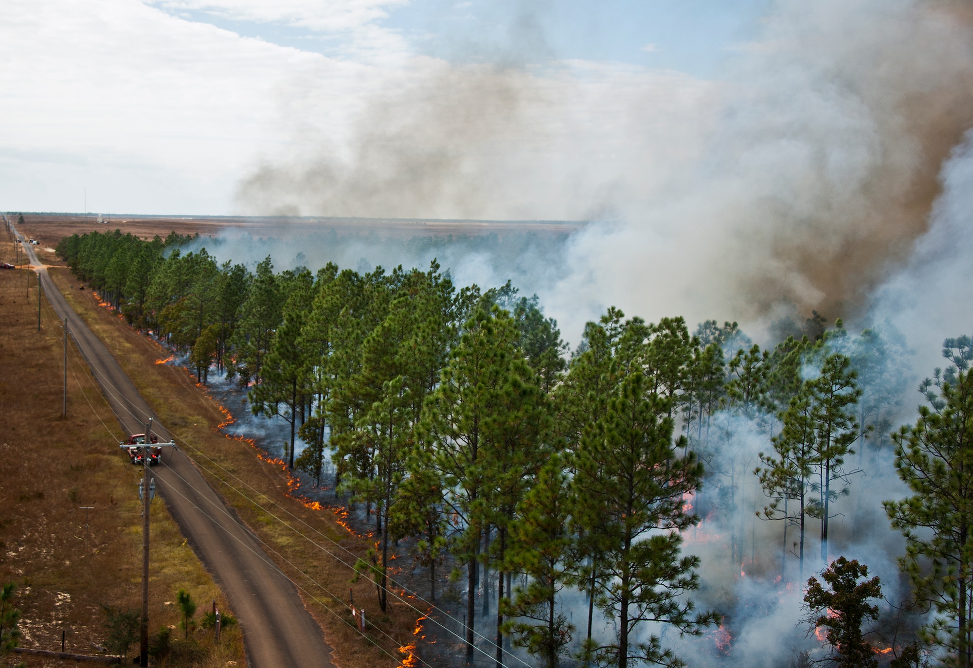 Fire consumes a 300-acre forest during a prescribed fire conducted at Eglin Air Force Base Nov. 11-12.  More than 90 scientists from the Combustion-Atmospheric-Dynamics-Research-Experiment team, sent from institutions all over the world, set up instruments to record meteorology, smoke particulates and other fire phenomena. (U.S. Air Force photo/Randy Gon)
