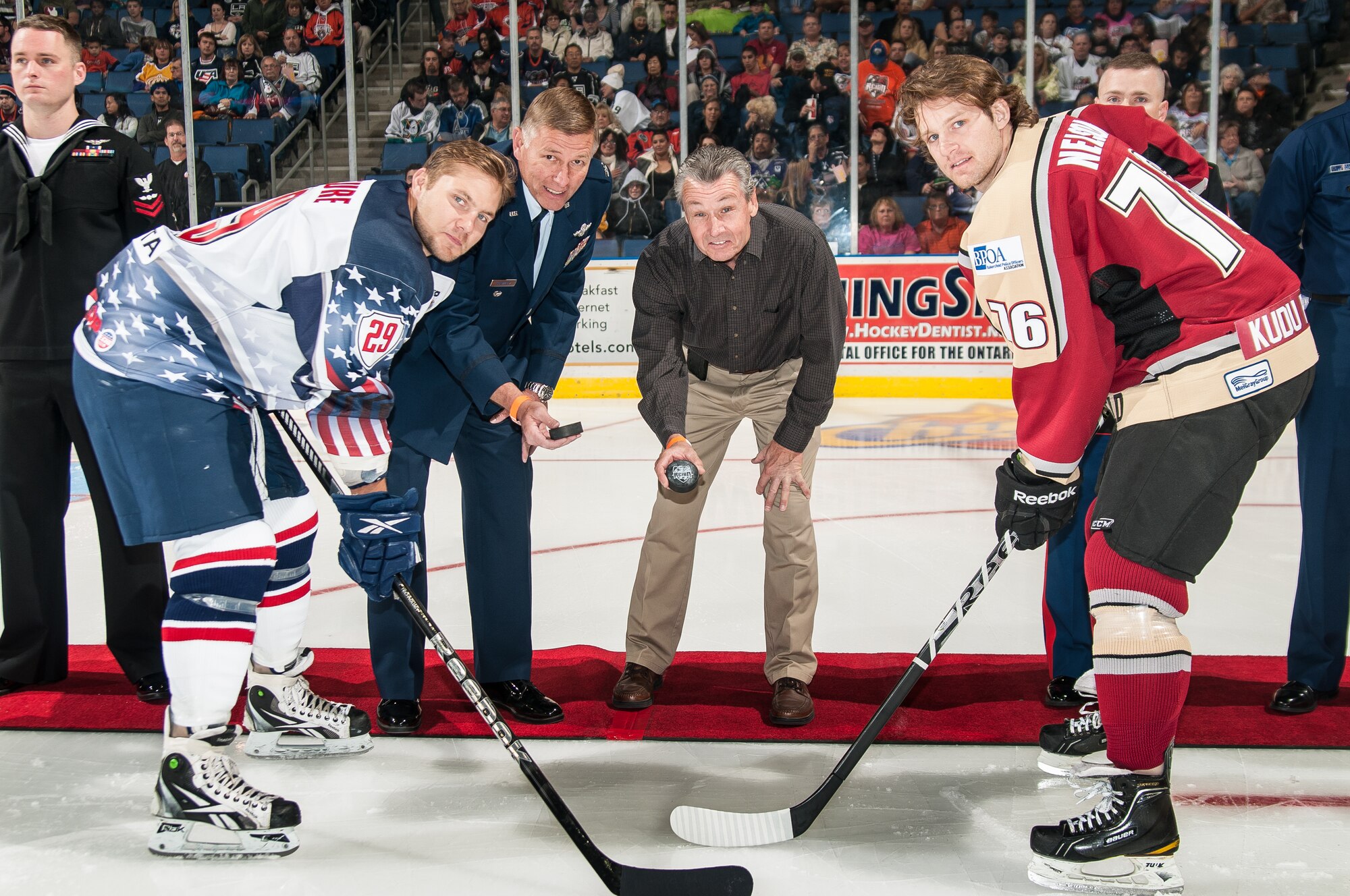 Col. Douglas Schwartz, 4th AF Director of Staff (second from left), holds the puck he recently dropped at the Ontario Reign/Bakersfield Condors hockey game on November 4. The game was dedicated to military members. All the services were recognized on the ice and the honor guard presented the colors. (Photo courtesy to U.S. Air Force)