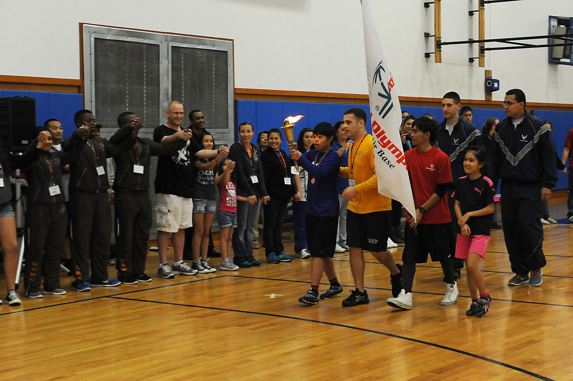 Takumu Ikemiya, a Kadena Special Olympics athlete, runs a torch around the circle of friendship on Kadena Air Base, Japan, Nov. 17, 2012. The KSO is a one-day sporting and entertainment event with more than 1,500 athletes special needs athletes and artists participating in a day of competition, music and special recognition. (U.S. Air Force photo/Airman 1st Class Malia Jenkins)  
