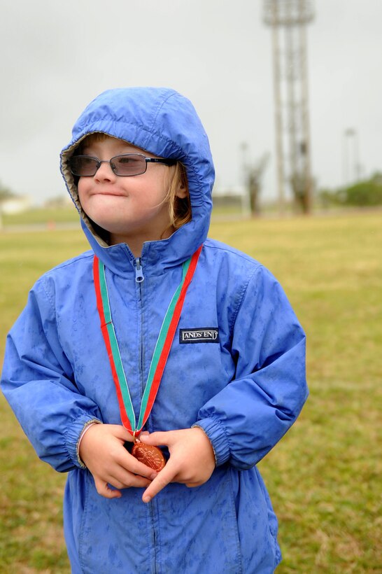 Marlee McDaniel poses with her medal at Kadena Special Olympics on Kadena Air Base, Japan, Nov. 17, 2012. Marlee is the 7-year-old daughter of the 18th Wing vice commander Col. Brian McDaniel and is participating in KSO for the first time. (U.S. Air Force photo/Airman 1st Class Brooke P. Beers)