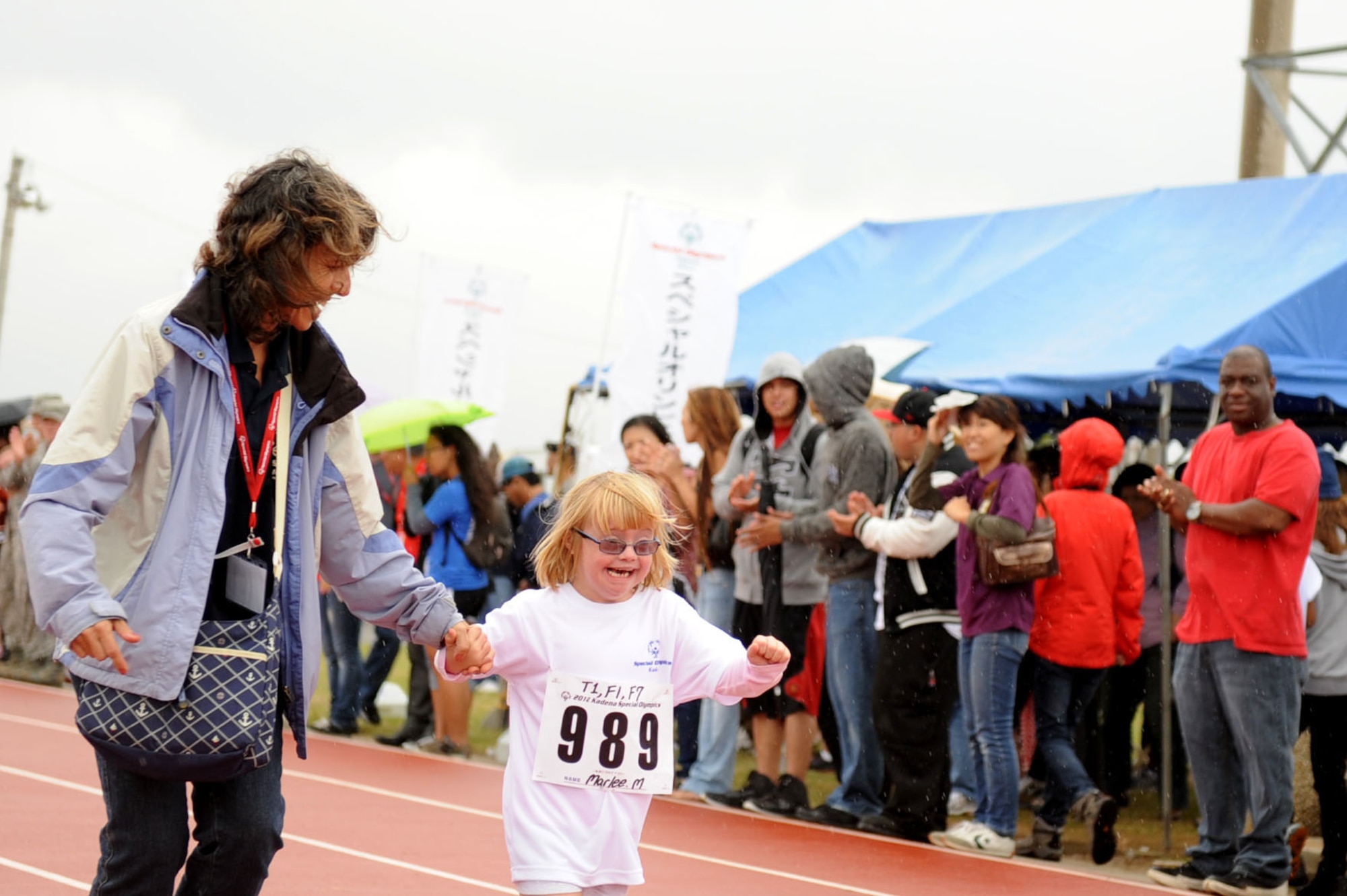 Marlee McDaniel, daughter of U.S. Air Force Col. Brain McDaniel, 18th Wing vice commander, runs the 30 meter dash for her fist event at the Kadena Special Olympics on Kadena Air Base, Japan, Nov. 17, 2012. Marlee is participating in KSO for the first time this year and also participated in the 30 meter dash, and softball throw. (U.S. Air Force photo/Airman 1st Class Brooke P. Beers)