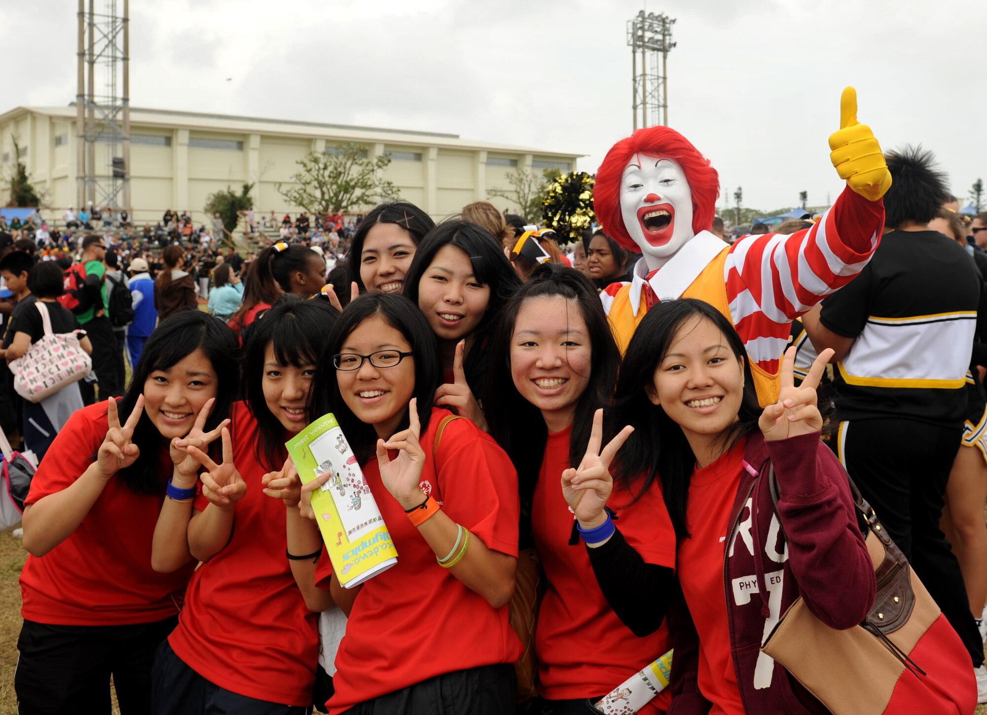 Ronald McDonald poses for a photo with volunteers during the 13th annual Kadena Special Olympics on Kadena Air Base, Japan, Nov. 17, 2012. The Kadena Special Olympics is a one-day sporting and entertainment event with more than 1,500 special-needs athletes and artists participating in a day of competition, music and special recognition. (U.S. Air Force photo/Airman 1st Class Hailey Davis)