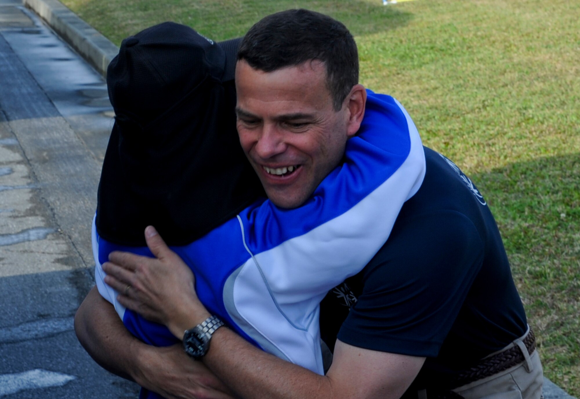 U.S. Air Force Brig. Gen. Matt Molloy, 18th Wing commander, receives a hug from a special-needs athlete during the beginning of the 13th annual Kadena Special Olympics on Kadena Air Base, Japan, Nov. 17, 2012. Kadena Special Olympics was established in 2000 by the 18th Wing commander as an avenue to build relations with neighboring communities and local government representatives while providing a meaningful activity for the special needs children and adults.(U.S. Air Force photo/Airman 1st Class Justin Veazie)