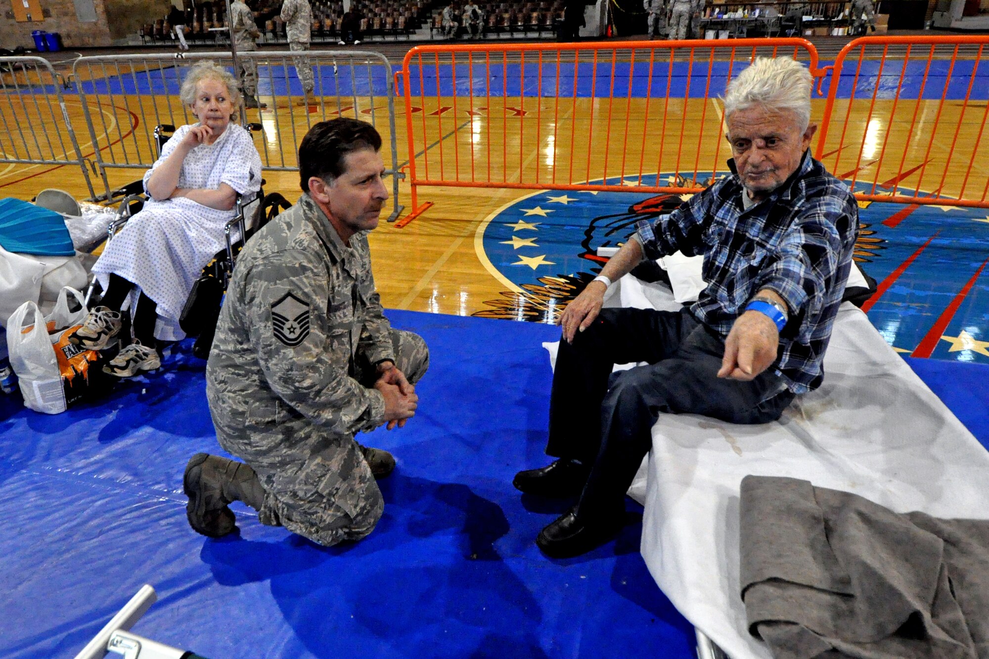 Master Sgt. Steven Sabato, 108th Wing, New Jersey Air National Guard, listens attentively to the request of one of the displaced residents at the shelter in Jersey City, Nov. 7. The New Jersey National Guard is providing sheltering for displaced Jersey City residents at the Jersey City armory in the aftermath of Hurricane Sandy. (U.S. Air Force photo by Staff Sgt. Armando Vasquez/Released)