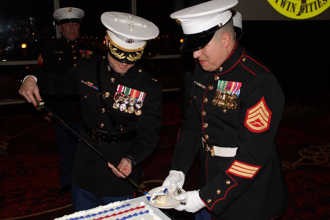 Marine veteran Don Weber watches Recruiting Station Twin Cities Commanding Officer Maj. Kenneth Gawronski and Staff Sgt. Jowa Wildes cut a piece of cake for the oldest and youngest Marine present at their 237th Marine Corps Birthday Ball at the Crowne Plaza St. Paul Riverfront on Nov. 17. Weber was the guest of honor and oldest Marine present at the event.