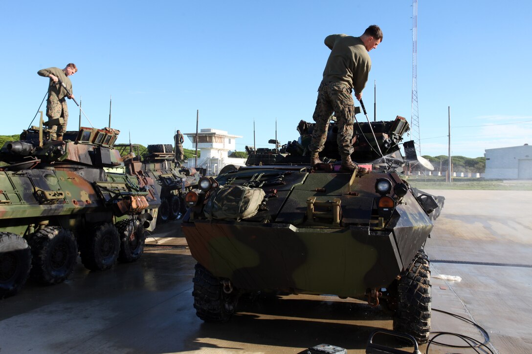 Marines with Weapons Company, Battalion Landing Team 1st Battalion, 2nd Marine Regiment, 24th Marine Expeditionary Unit, spray their light armored vehicles during wash down procedures aboard Naval Station Rota, Spain, Nov. 11, 2012. Marines conducted the wash down to clean dirt and debris from their vehicles and equipment in preparation for their scheduled return to their home bases in North Carolina later this year. The 24th MEU is deployed with the Iwo Jima Amphibious Ready Group and is currently in the 6th Fleet Area of Responsibility as a disaster relief and crisis response force. Since deploying in March, they have supported a variety of missions in the U.S. Central and European Commands, assisted the Navy in safeguarding sea lanes, and conducted various bilateral and unilateral training events in several countries in the Middle East and Africa.