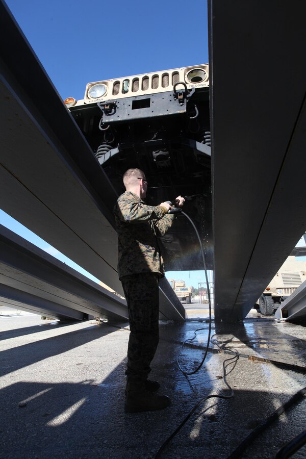 A Marine with 24th Marine Expeditionary Unit sprays the undercarriage of a Humvee during wash down procedures aboard Naval Station Rota, Spain, Nov. 11, 2012. Marines conducted the wash down to clean dirt and debris from their vehicles and equipment in preparation for their scheduled return to their home bases in North Carolina later this year. The 24th MEU is deployed with the Iwo Jima Amphibious Ready Group and is currently in the 6th Fleet Area of Responsibility as a disaster relief and crisis response force. Since deploying in March, they have supported a variety of missions in the U.S. Central and European Commands, assisted the Navy in safeguarding sea lanes, and conducted various bilateral and unilateral training events in several countries in the Middle East and Africa.