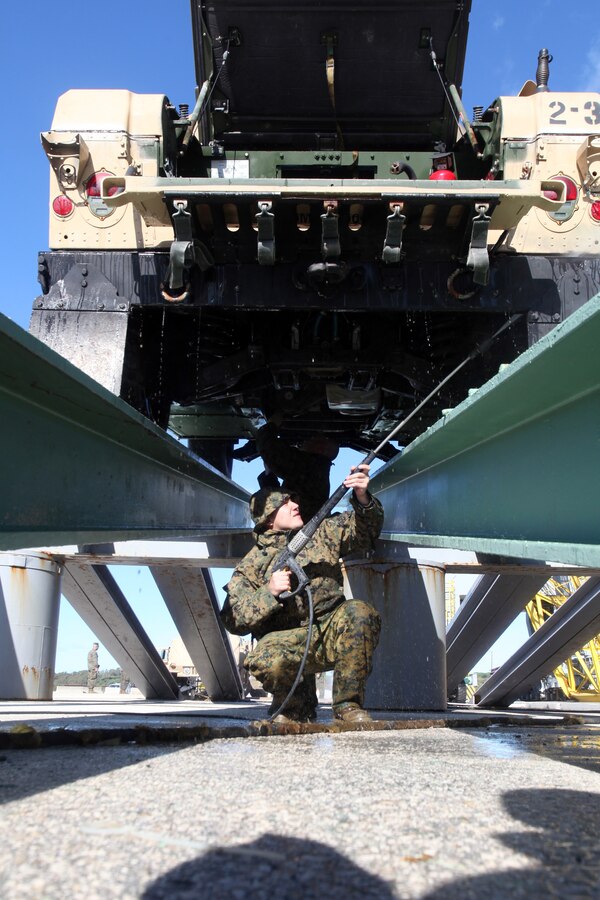 A Marine with 24th Marine Expeditionary Unit sprays the undercarriage of a Humvee during wash down procedures aboard Naval Station Rota, Spain, Nov. 11, 2012. Marines conducted the wash down to clean dirt and debris from their vehicles and equipment in preparation for their scheduled return to their home bases in North Carolina later this year. The 24th MEU is deployed with the Iwo Jima Amphibious Ready Group and is currently in the 6th Fleet Area of Responsibility as a disaster relief and crisis response force. Since deploying in March, they have supported a variety of missions in the U.S. Central and European Commands, assisted the Navy in safeguarding sea lanes, and conducted various bilateral and unilateral training events in several countries in the Middle East and Africa.