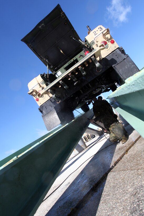 A Marine with 24th Marine Expeditionary Unit sprays the undercarriage of a Humvee during wash down procedures aboard Naval Station Rota, Spain, Nov. 11, 2012. Marines conducted the wash down to clean dirt and debris from their vehicles and equipment in preparation for their scheduled return to their home bases in North Carolina later this year. The 24th MEU is deployed with the Iwo Jima Amphibious Ready Group and is currently in the 6th Fleet Area of Responsibility as a disaster relief and crisis response force. Since deploying in March, they have supported a variety of missions in the U.S. Central and European Commands, assisted the Navy in safeguarding sea lanes, and conducted various bilateral and unilateral training events in several countries in the Middle East and Africa.