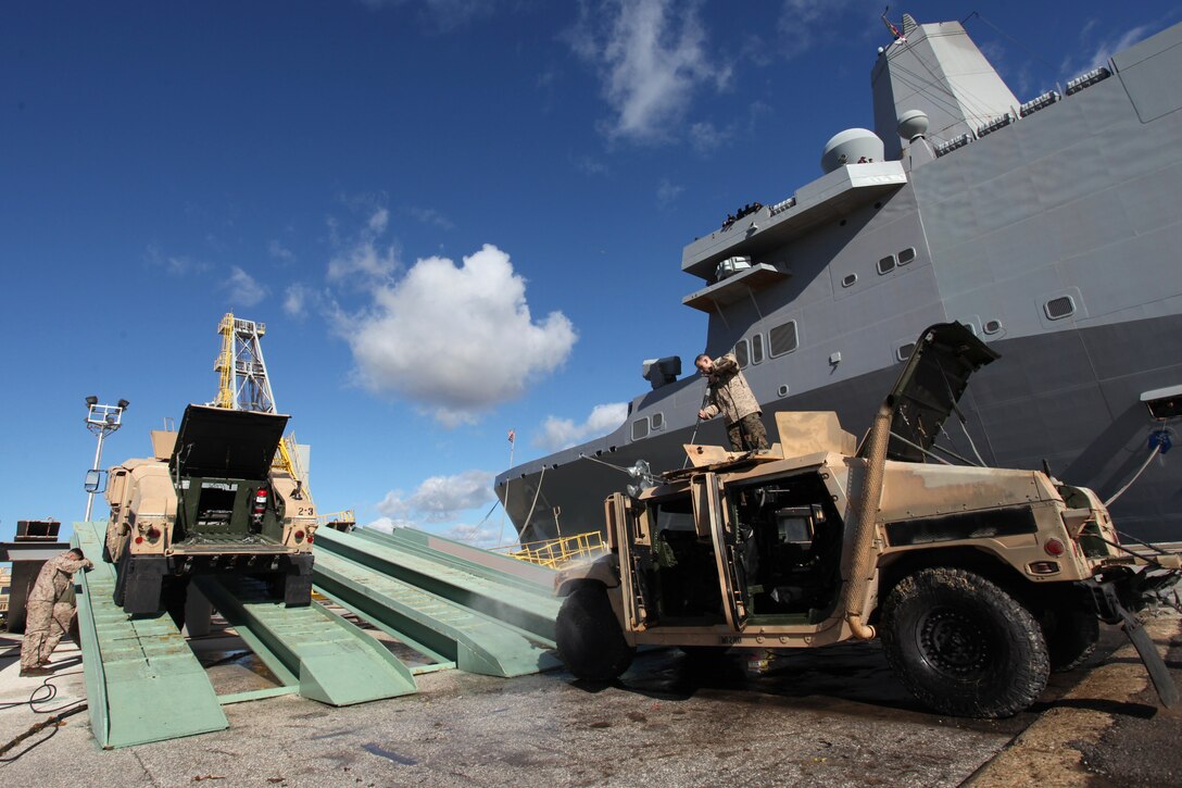 Marines with 24th Marine Expeditionary Unit spray Humvees during wash down procedures aboard Naval Station Rota, Spain, Nov. 11, 2012. Marines conducted the wash down to clean dirt and debris from their vehicles and equipment in preparation for their scheduled return to their home bases in North Carolina later this year. The 24th MEU is deployed with the Iwo Jima Amphibious Ready Group and is currently in the 6th Fleet Area of Responsibility as a disaster relief and crisis response force. Since deploying in March, they have supported a variety of missions in the U.S. Central and European Commands, assisted the Navy in safeguarding sea lanes, and conducted various bilateral and unilateral training events in several countries in the Middle East and Africa. 