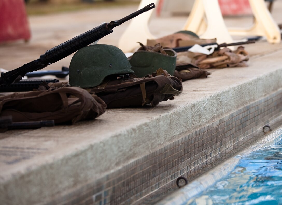 Combat gear lays at the side of a pool before being used during the gear rescue evolution of a Marine Corps Instructor of Water Survival course at the base pool on Marine Corps Base Hawaii, Nov. 12.
