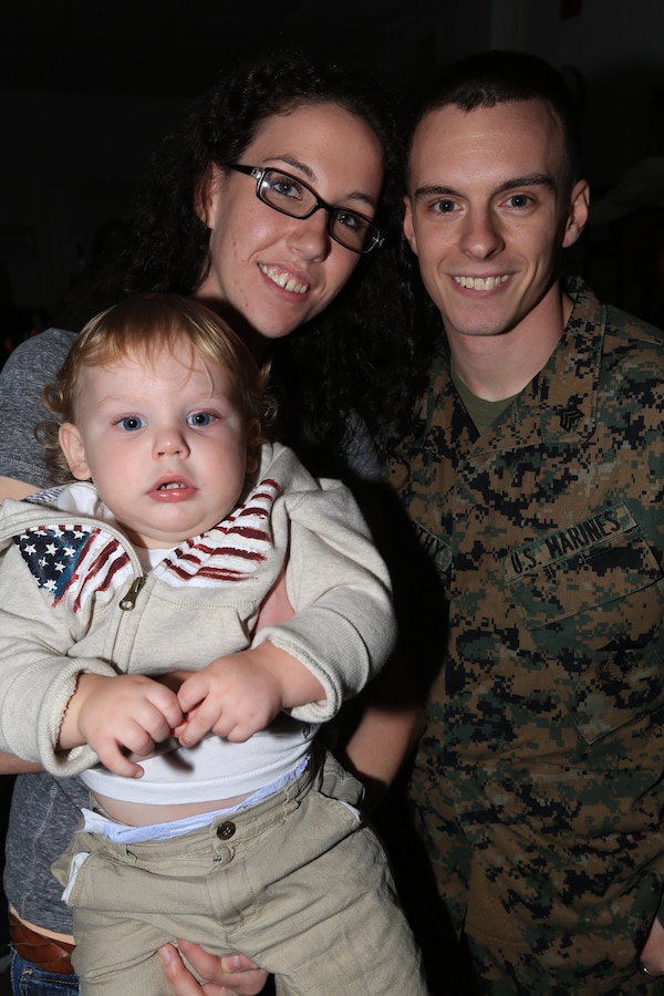 Sgt. Casey McMarthy, a Montgomery, Ala., native and a data network specialist with the Joint Task Force Enabler, 24th Marine Expeditionary Unit, poses for a photograph with his wife and one-year-old son inside the 24th MEUs headquarters building on Marine Corps Base Camp Lejeune Nov. 13, 2012, after returning from an eight-month deployment. The Marines are part of the 24th MEU's Joint Task Force Enabler, or JTFE, section, which was responsible for the coordination of communications assets throughout the entire 24th MEU, both on land and at sea. The JTFE were deployed at Naval Air Station Sigonella, Italy.